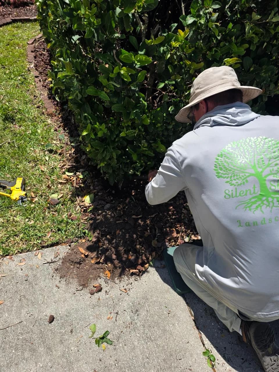 Silent Shade Landscaping worker maintaining a residential bed